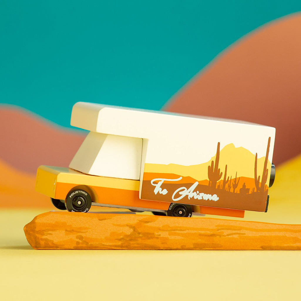 Candylab's yellow-and-orange RV toy, perfect for adventure lovers.