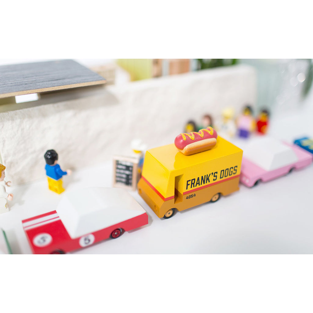Candylab hot dog van toy shown in a Lego village for creative storytelling.