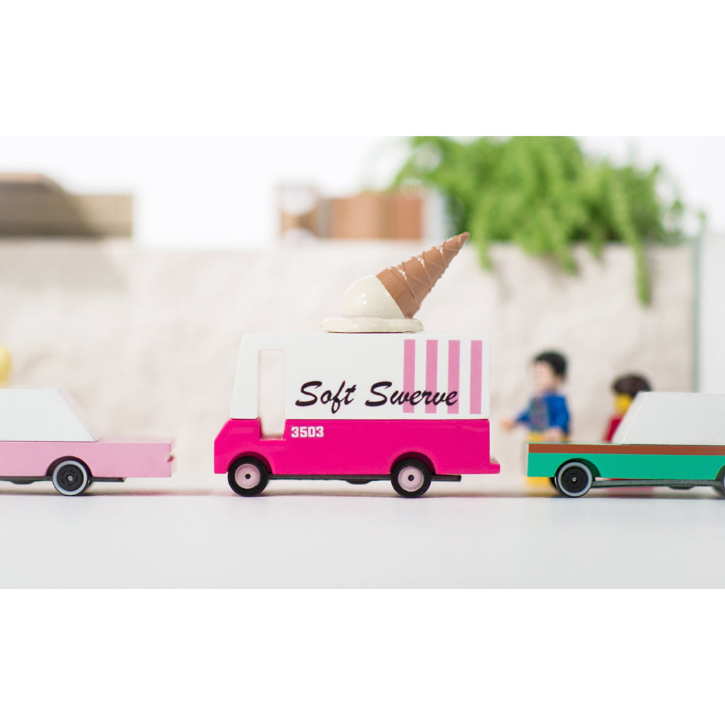 Candylab ice cream van toy displayed alongside other wooden vehicles for kids.