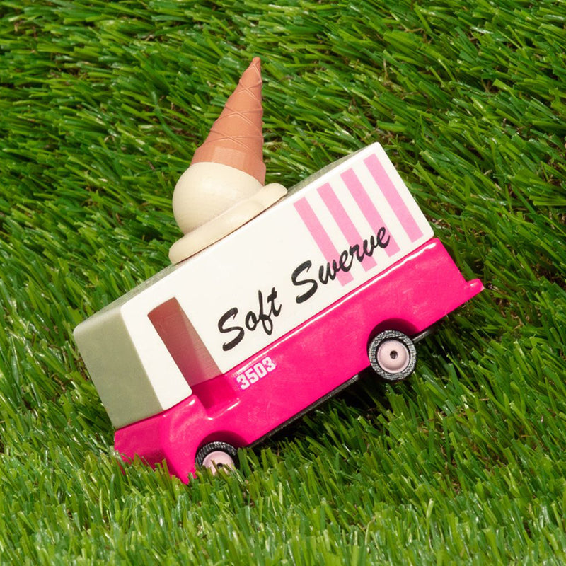 Ice cream truck toy parked on grass, wooden design by Candylab Toys.