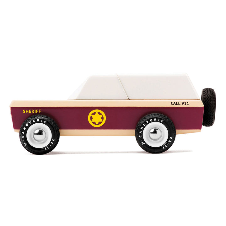 Side profile of Candylab Toys Lone Sheriff car, a retro wooden toy for kids.