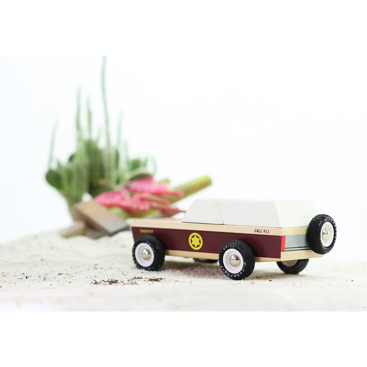 Candylab Lone Sheriff car placed on a desert-themed playset for storytelling.