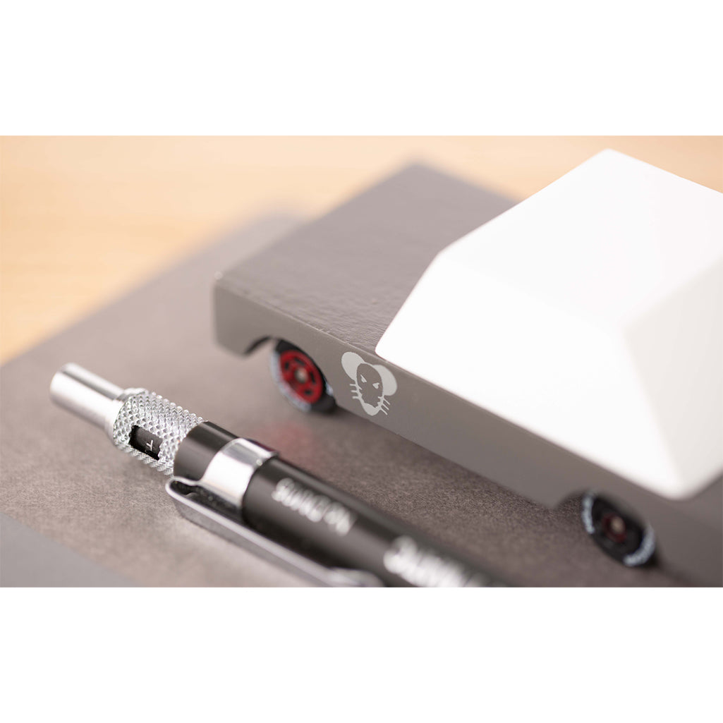 A Candylab Toys Mouse Rod wooden toy car with a pen placed beside it for scale comparison.