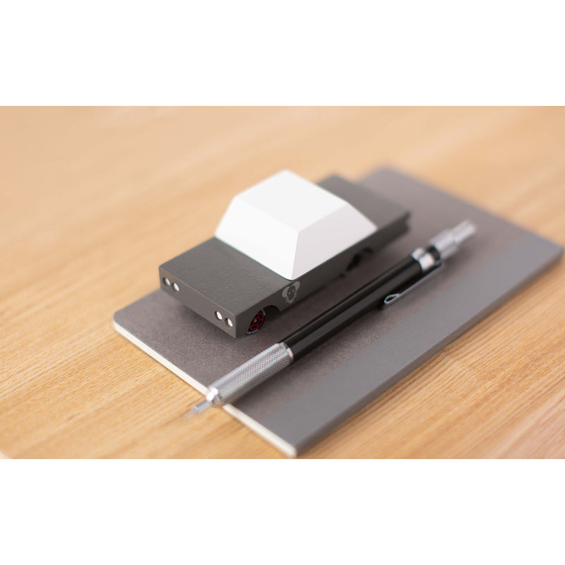 A black-and-white version of the Candylab Toys Mouse Rod wooden car, perfect for collectors and kids alike.
