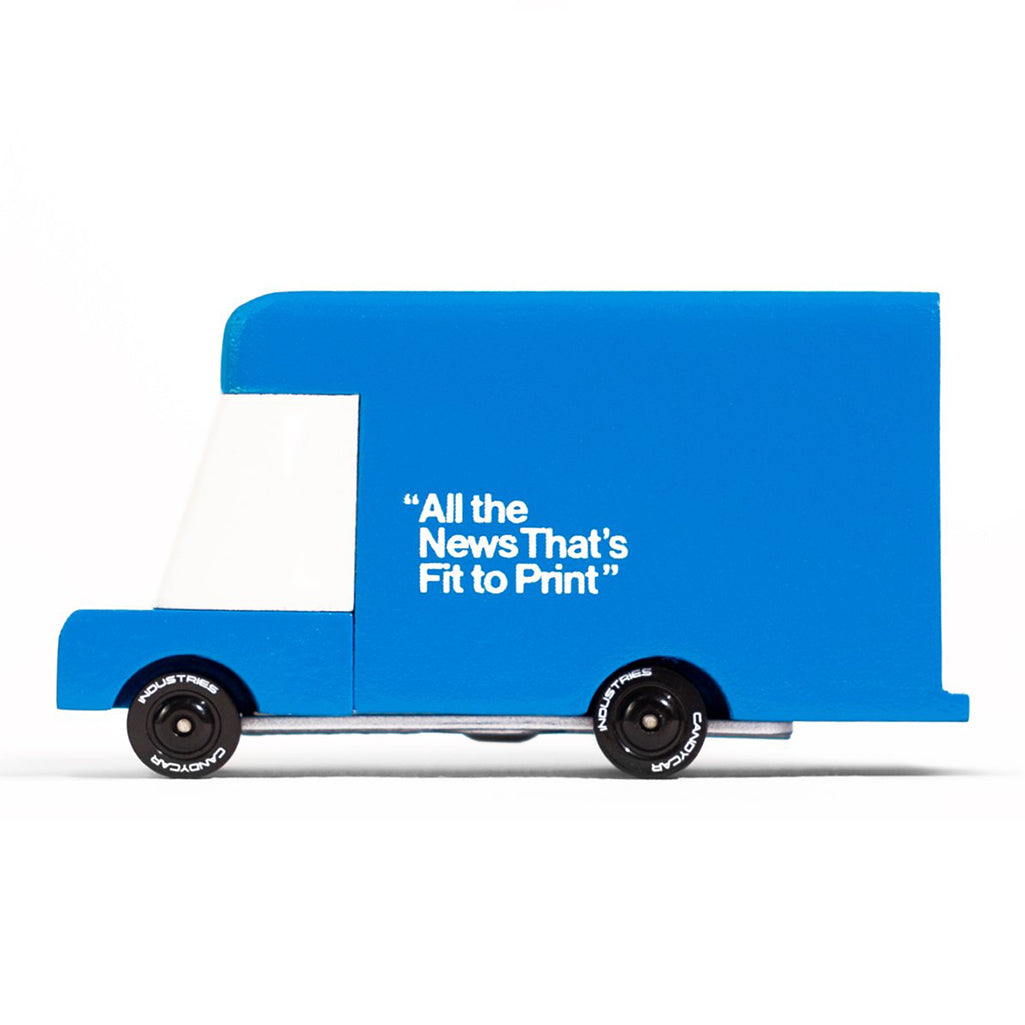 A blue Candylab Toys New York Times wooden van, designed for kids to play with and explore.