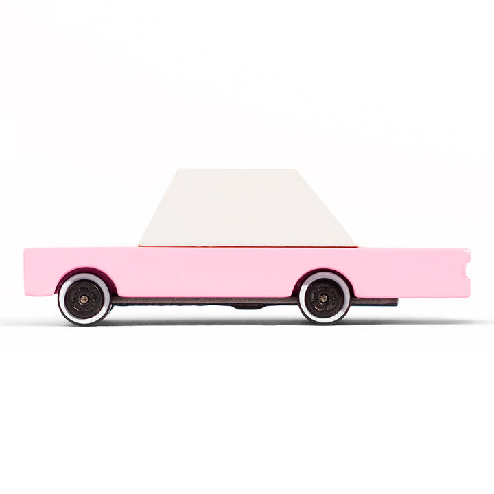 A Candylab Toys pink sedan wooden toy car, perfect for children to enjoy pretend driving scenarios.