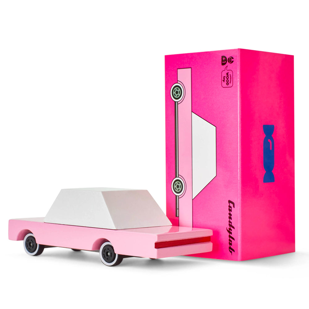 A Candylab Toys bubblegum pink sedan wooden car, packaged and ready for pretend play adventures.