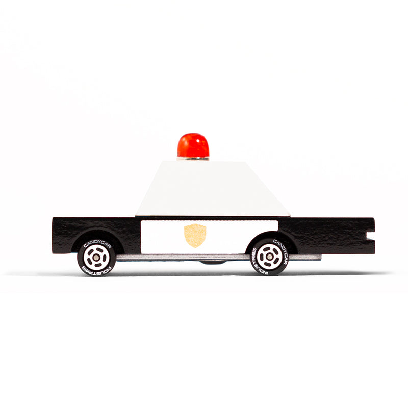 A wooden police car designed by Candylab Toys, perfect for kids to role-play as officers on the move.