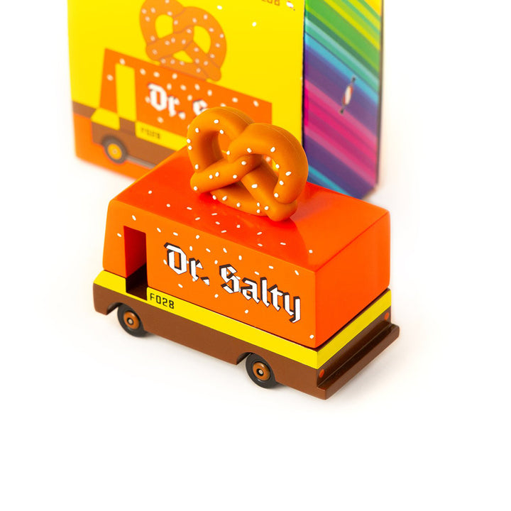 A wooden Candylab Toys Pretzel Van with packaging, designed for childrens pretend cooking and food truck play.