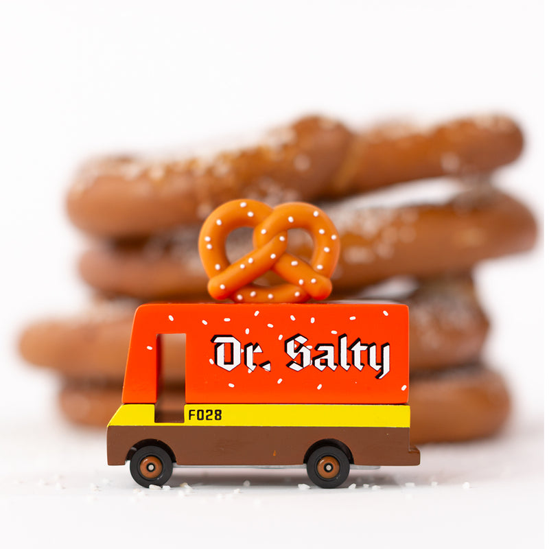 A wooden Candylab Toys Pretzel Van with miniature pretzels, ready for pretend food truck fun.