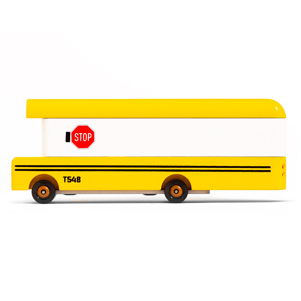 A wooden yellow school bus toy by Candylab Toys, designed for children to enjoy pretend school bus play.