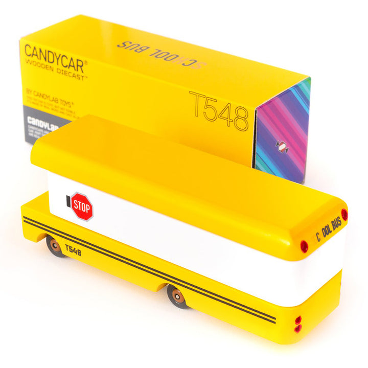 A Candylab Toys yellow wooden school bus, perfect for children to role-play as drivers or passengers.