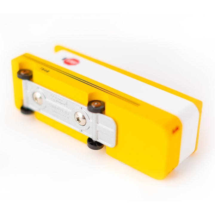 The bottom of a Candylab Toys wooden yellow school bus, highlighting its sturdy wooden construction.