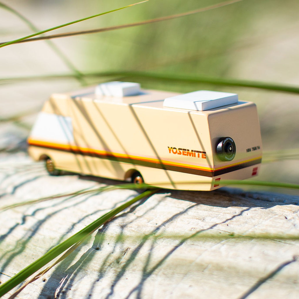 Candylab Toys Yosemite RV Wooden Camper placed outdoors, creating a realistic adventure scene