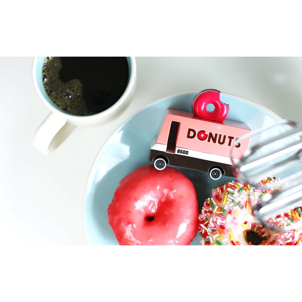 Candylab donut van placed on a plate of donuts combining wooden toy fun with a sweet theme