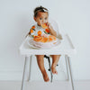 Baby wearing Clementine Kids Citrus Muslin Bib