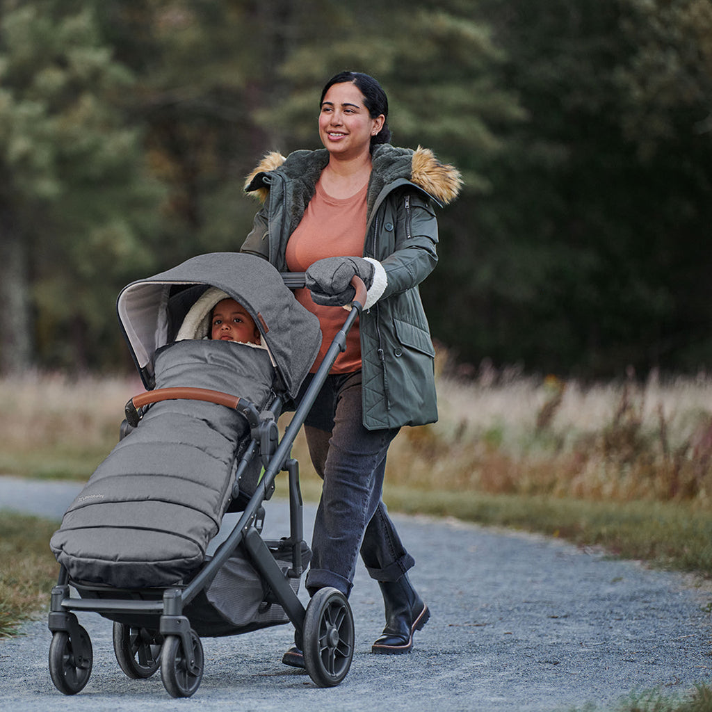 Woman Walking with UPPAbaby Greyson CRUZ V2 Stroller with CozyGanoosh