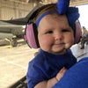 Baby wearing pink Banz Hearing Protection Earmuffs