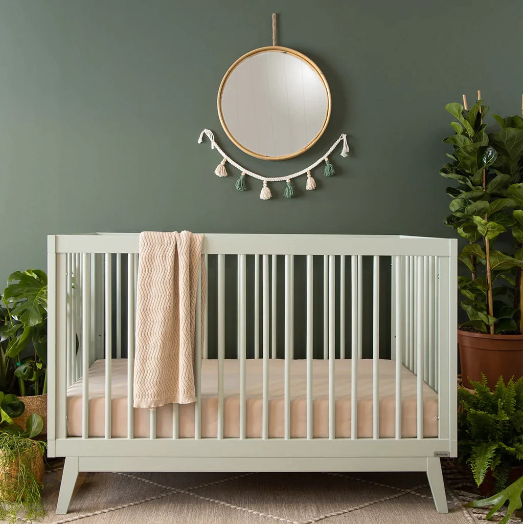 Lifestyle image of Soho Crib in Sage in a nursery. Baby nursery furniture