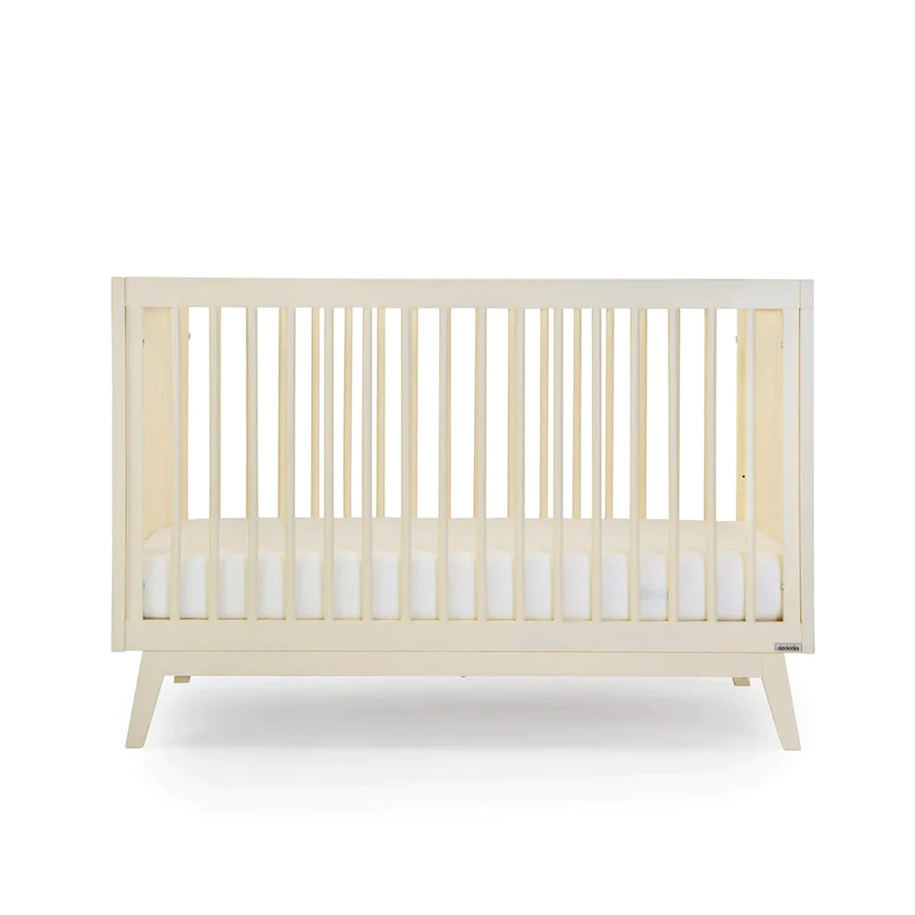 dadada Meringue Soho 3-in-1 Convertible Crib to Toddler Bed Furniture . Light creamy yellow in color. Face view.