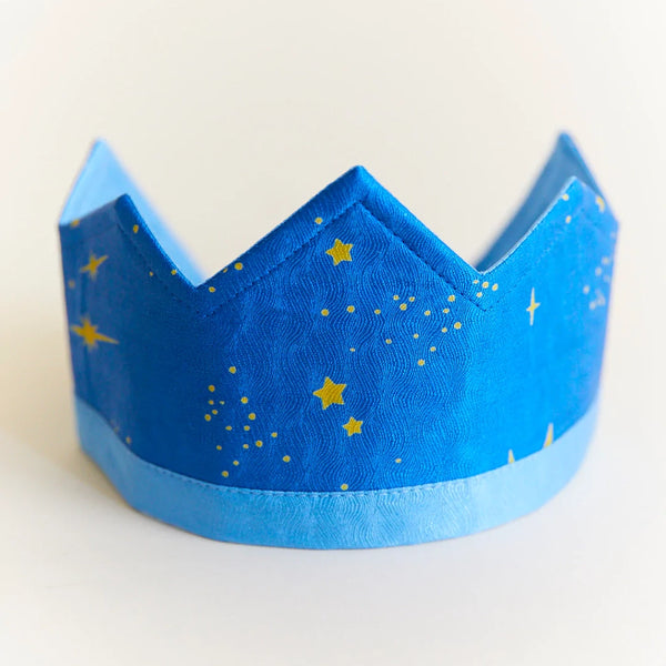 Sarah's Silk Star Silk Crown Children's Pretend Dress-Up Crown. Bright Blue silk crown with light blue band around the bottom. Golden starts and dots spattered all around the bright blue portion. Elastic band around the back.