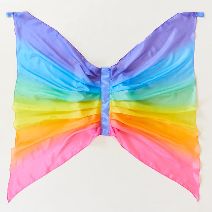 Sarah's Silks Rainbow Fairy Wings Children's Dress-Up Accessory. Ombre rainbow silk dress-up fairy wings for children. Each wing has a small silk loop at the top for children to grab. Elastic loops attached to back of wings for wear.