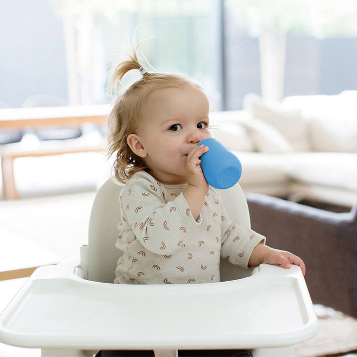 Child using the blue mini cup