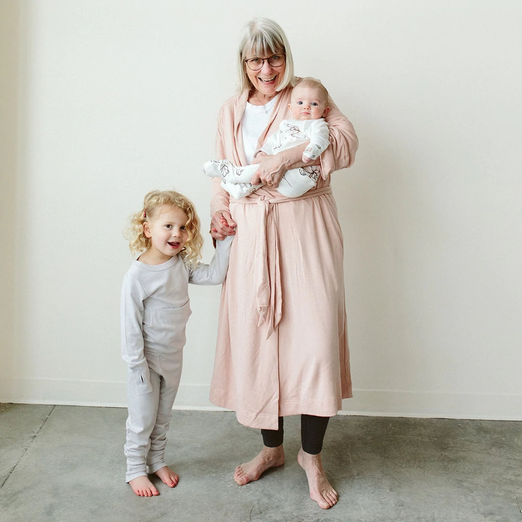 Goumikid's Rose Bamboo Organic Cotton Women's Robe. Light pink women's robe with sewn in tie. Featured on model with children.