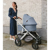 Woman Pushing Uppababy Cruz Stroller with Bassinet Accessory
