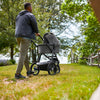 Dad Pushing Uppababy Cruz Stroller with Bassinet Accessory