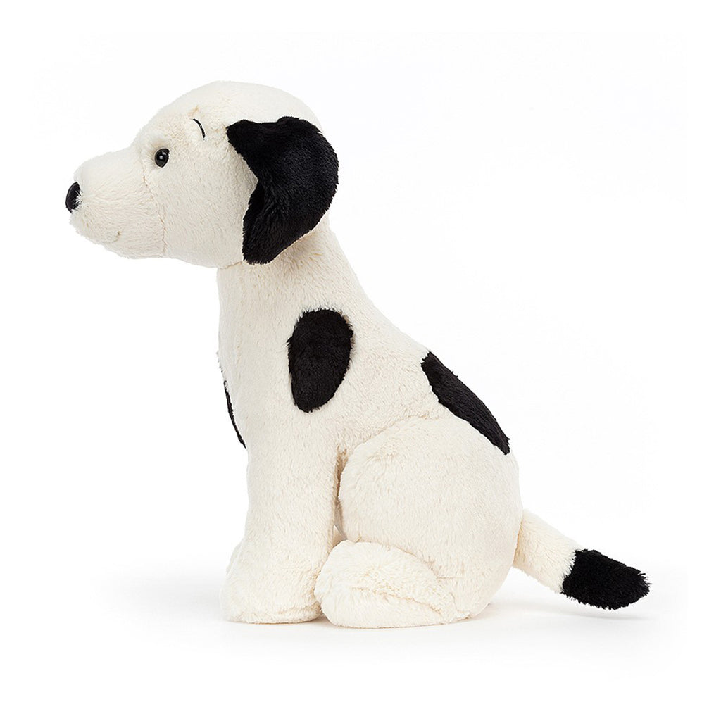Jellycat Harper Pup. Black & White spotted dog stuffed animal. Side view.
