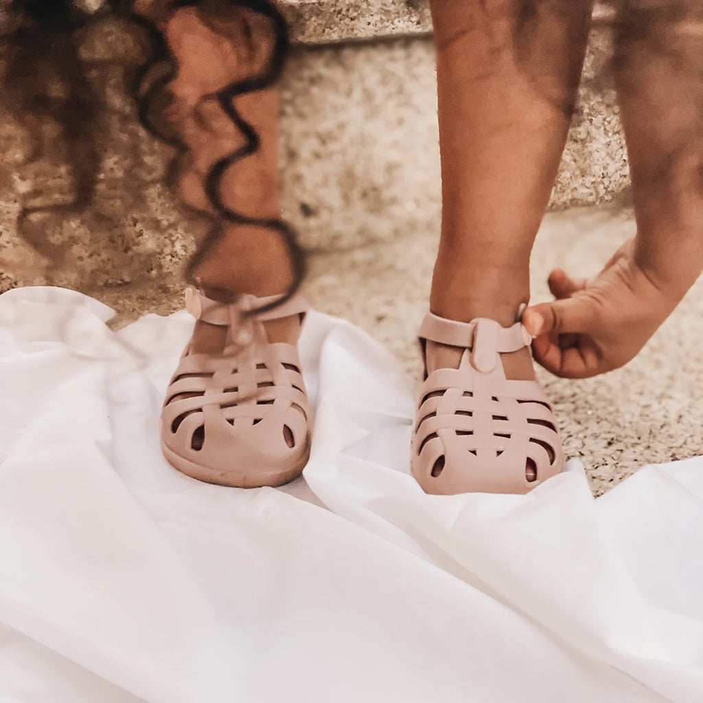 Mrs Ertha Blush Floopers Children's Silicone Summer Sandals modeled on child.