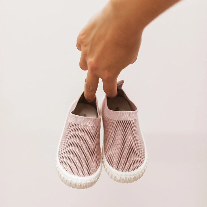 Mrs Ertha's Blush Mocs Children's Slip-on Summer Shoes. Shown being held by child.