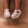Mrs Ertha Coconut Milk Floopers Children's Silicone Summer Sandals modeled on child.