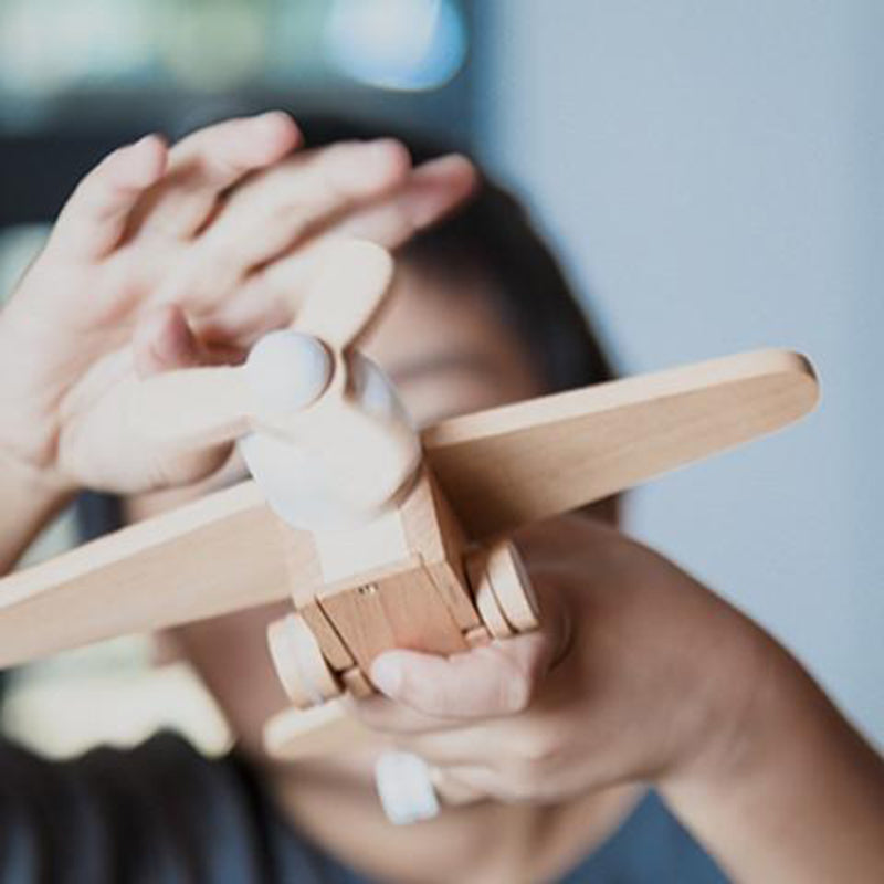 Montessori-inspired wooden plane toy by Kiko+, featuring a realistic propeller.