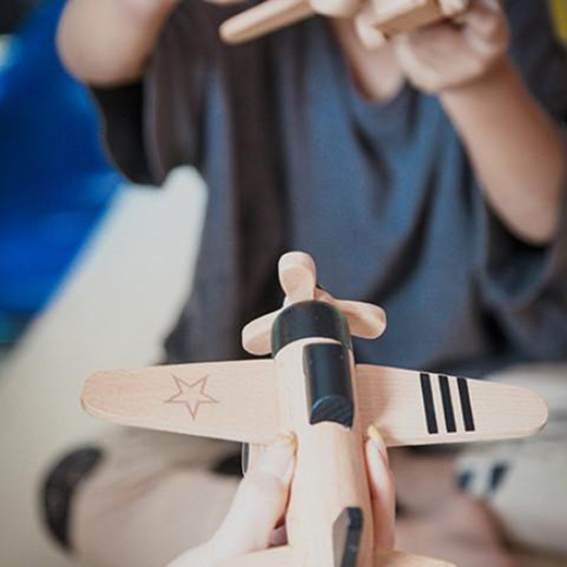 Kiko+ handcrafted wooden toy plane with a smooth finish and functioning wheels.