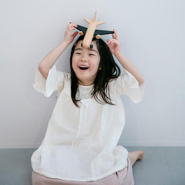 Kiko+ wind-up jet toy, a wooden airplane for kids' imaginative adventures.