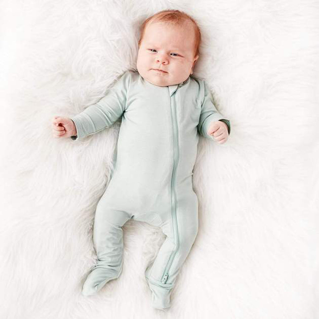 kytebaby footed pajamas on baby in sage green