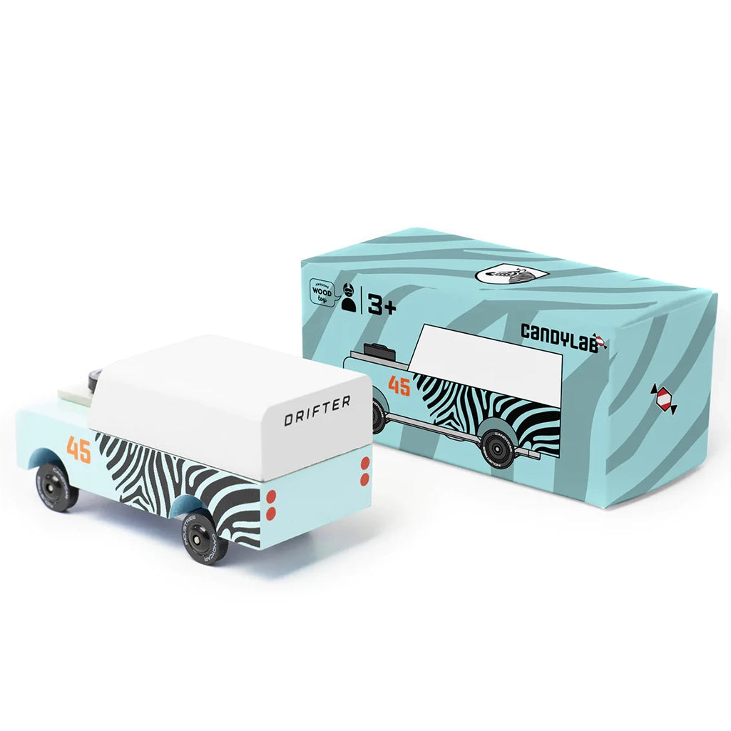 A Candylab Mini Zebra Drifter children's wooden toy vehicle shown with its packaging for a gift-ready presentation.