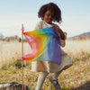 Lifestyle image of child using a Mini Playsilk as a flag outside.