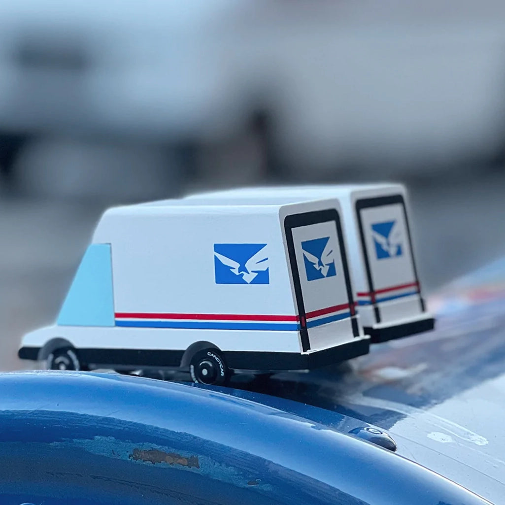 Candylab futuristic mail van toy, displayed in a natural play environment.