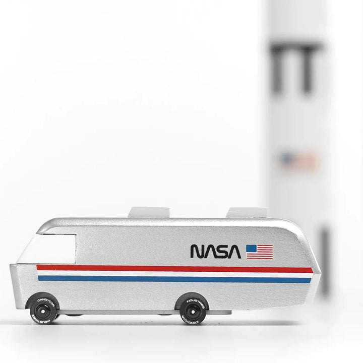 A lifestyle image of the Candylab NASA Astrovan wooden car, being used for pretend space exploration.