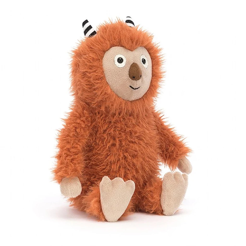 Jellycat Pip Monster Stuffed Animal Children's Toy. Burnt orange furry monster with tan face, hands, and feet. Two black and white striped horns on top of its head. Wide eyes and small brown nose with little stitched smile.