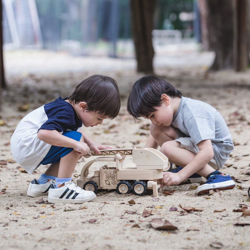 A wooden fire truck toy for children, designed for pretend fire-fighting adventures with a natural wood finish.