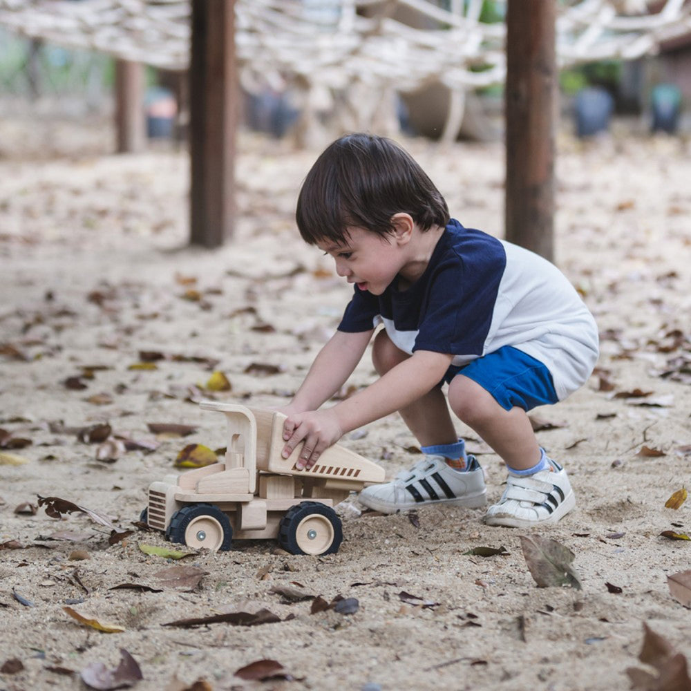 Durable wooden dump truck toy, perfect for creative play, made by PlanToys.