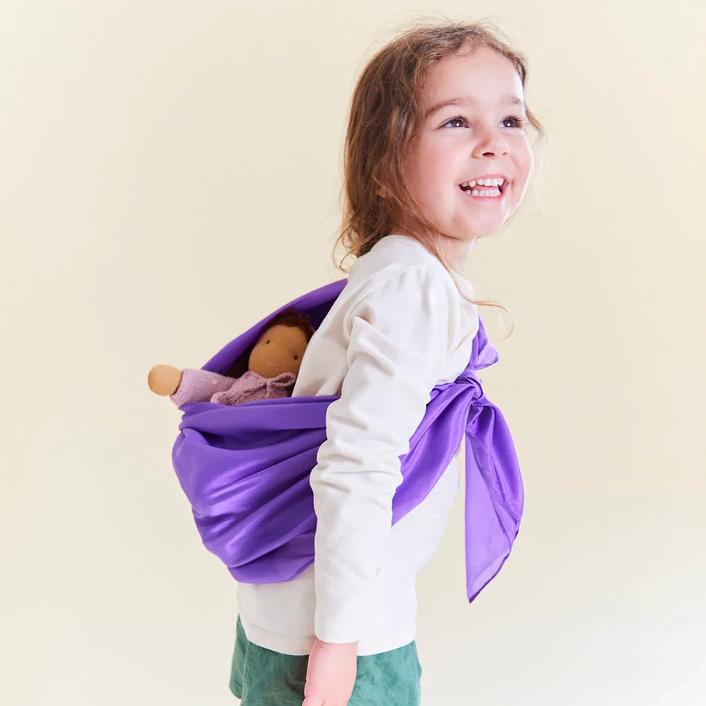 Sarah's Silks Purple Playsilk modeled on child using the playsilk as a baby doll carrier.