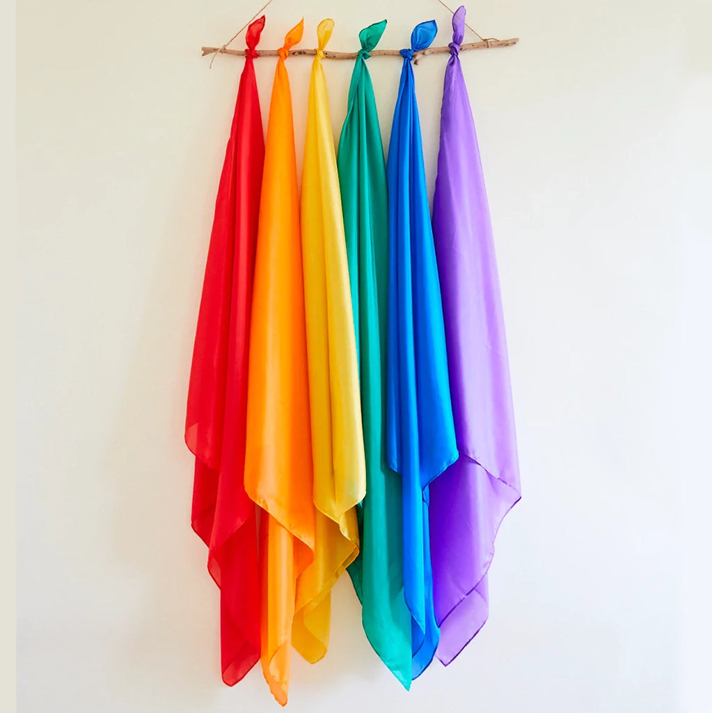 Image of various colors of Sarah's Silks Playsilks including red, orange. yellow, green, blue, and purple.