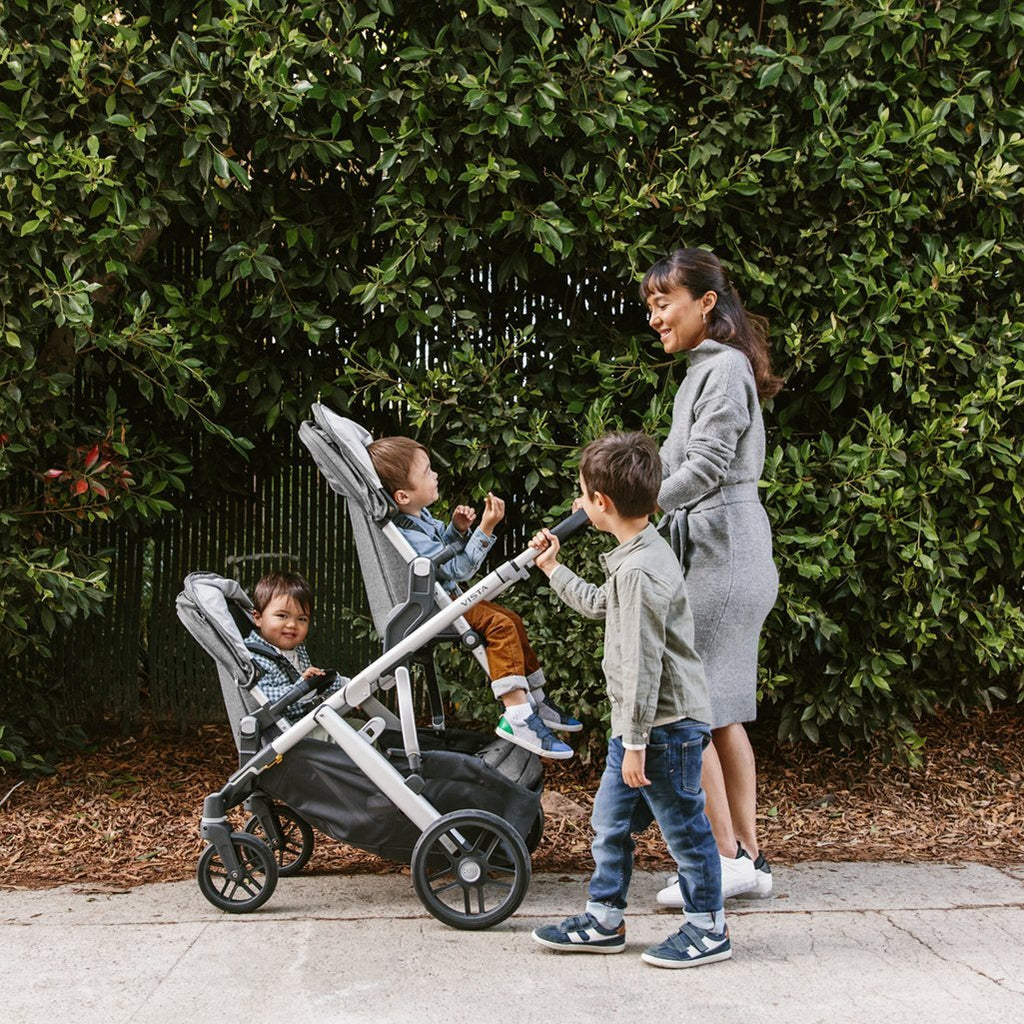 Mother walking with Two Children in VISTA Stroller from Uppababy