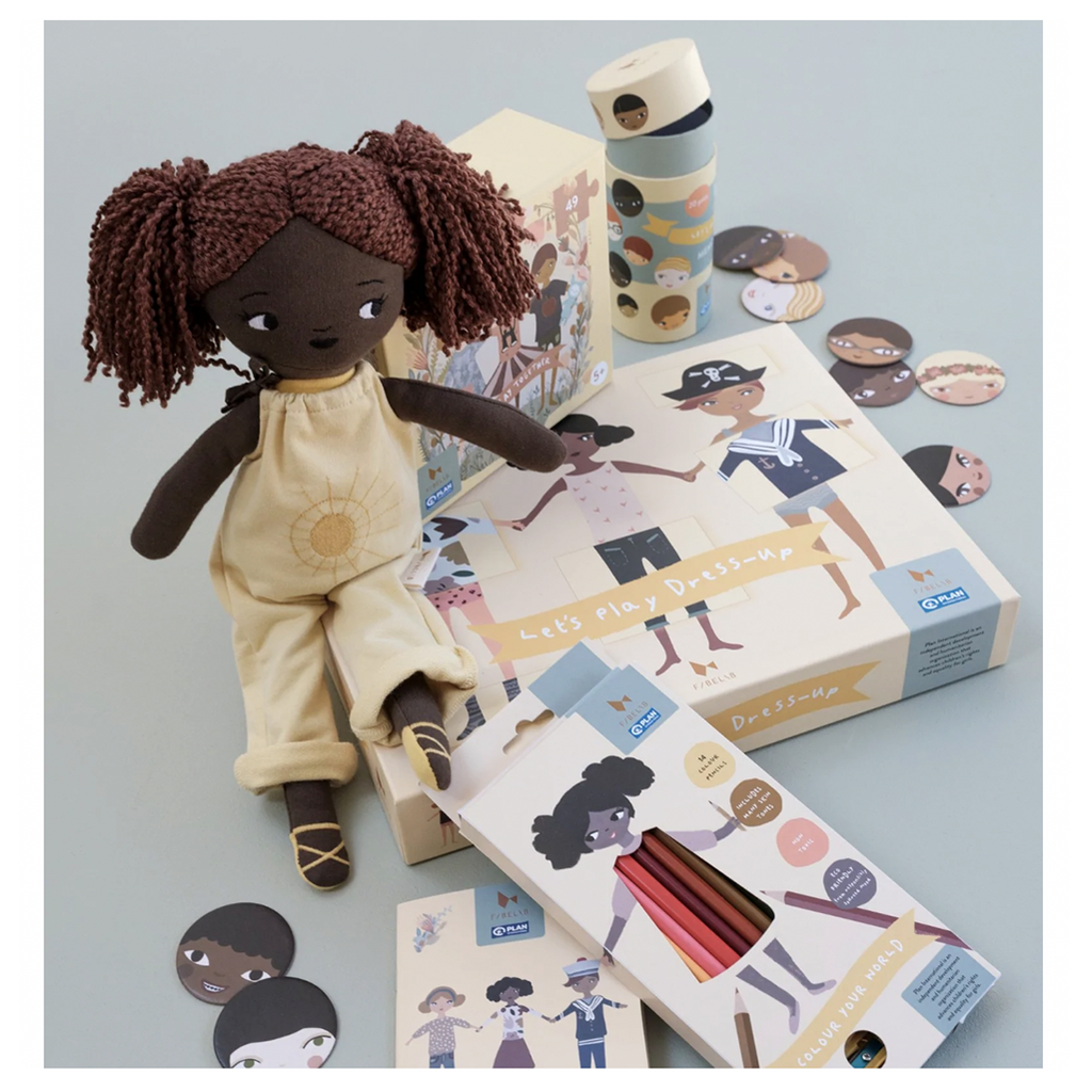 Lifestyle image of Fab Friends Sol doll and other Fabelab products.