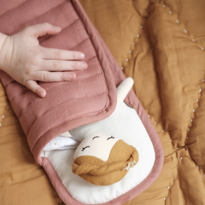 Clay sleeping bad shown with doll inside.